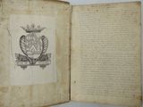 an open book with a drawing of a coat of arms and a crown on top of it