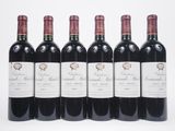 six bottles of red wine lined up in a row on a white surface
