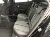 the back seats of a black car are empty and the seats are empty