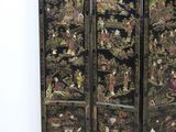 an image of a black four paneled screen with oriental scenes