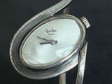 an image of a close up of a wrist watch with a curved band