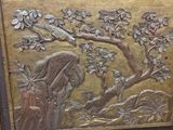 carvings on the side of a wooden chest of drawers in a room