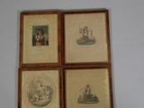 four framed pictures of people and animals on a wall in a room
