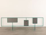 an image of a glass and metal sideboard in a white room