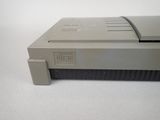 an old nintendo game console sitting on a white surface