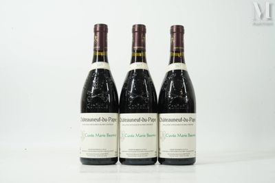 three bottles of wine are lined up on a white surface