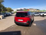 the red car is parked in the parking lot next to other cars