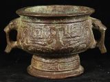 un gros plan d'un vase en bronze sur fond noir