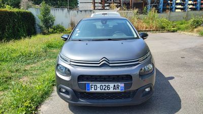 a small car that is parked on the side of the road