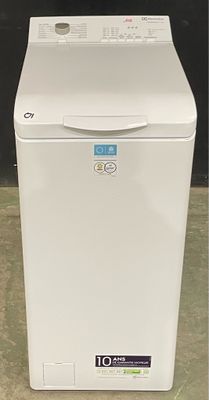 an image of a white washing machine sitting on the floor