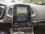 the dashboard of a car with a gps device in the center of it