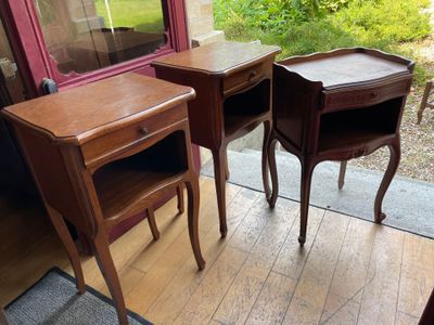 two tables and a chair in the corner of a room