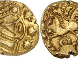 a close up of two gold coins on a white surface