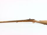 an old rifle on a white surface with a white background