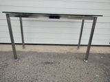 a glass table with a metal base and a glass top