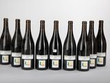 six bottles of wine lined up in a row on a table