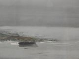 a painting of a boat in the water on a foggy day