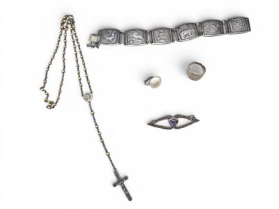 a necklace, bracelet, ring, and other jewelry on a white surface