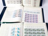 three open books with stamps on them sitting on top of a table