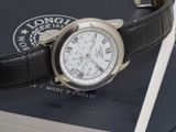 a watch sitting on top of a book on a table