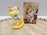 a small figurine of a girl on a surfboard
