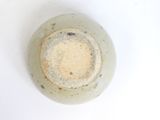 a white bowl with a brown rim sitting on a white surface