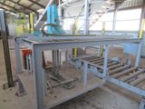 a machine that is working on pipes in a factory
