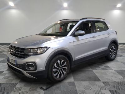 a silver volkswagen t - cross parked on a checkered floor