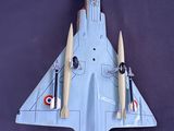a model of a fighter jet sitting on a black surface