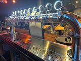 a row of beer taps on the bar at a restaurant