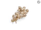 a close up of a pair of gold and diamond earrings