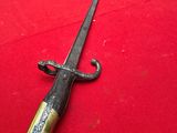 an old sword on a red cloth on a table
