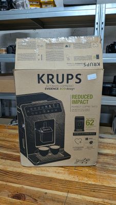 packaging of a coffee machine sitting on top of a wooden table