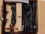 a cardboard box with a bunch of wires and cords in it