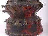 a vase that has a red and black design on it