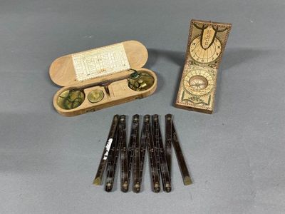 a box of pens and a pair of glasses on a table