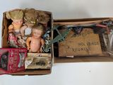 a box full of dolls and other items on a table