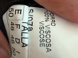 a close up of a person ' s hand holding a label on a piece of luggage