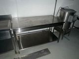 a kitchen with a sink and a table in it