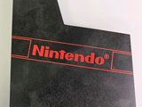 the nintendo logo is shown on the back of a black card