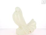 a white statue of a bird on a white surface