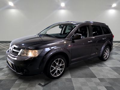 a picture of a black dodge grand caravan parked on a checkered floor