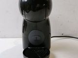 an image of a black coffee maker on a white table