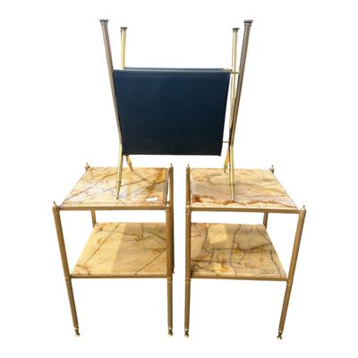pair of brass and marble side tables with black leather seats