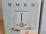 boxes for a toaster are stacked on a shelf in a store