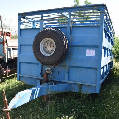 a blue trailer that has a tire on the back of it