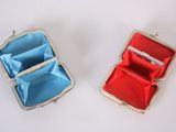 pair of red and blue purses sitting on top of a white surface