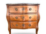 a small wooden chest of drawers with marble top