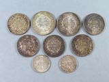 six different types of coins on a white surface