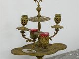 a three - tiered candle holder with candles on it
